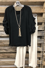 Chemisier noir uni à volants et col rond