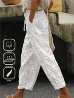 Pantalon droit ample et uni avec poches et coutures apparentes, idéal pour les vacances.