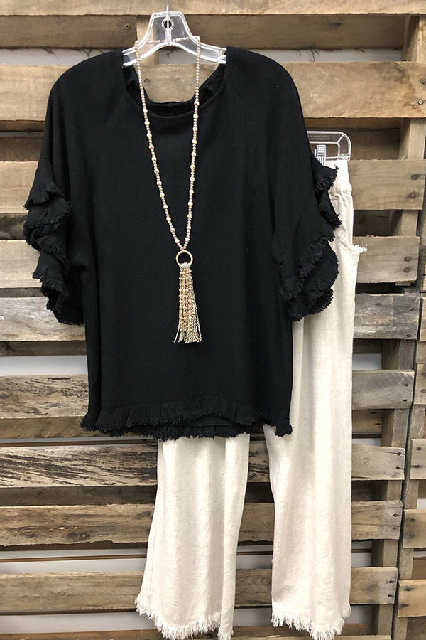 Chemisier noir uni à volants et col rond