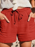 Pantalon uni à poches latérales et taille élastique avec cordon de serrage